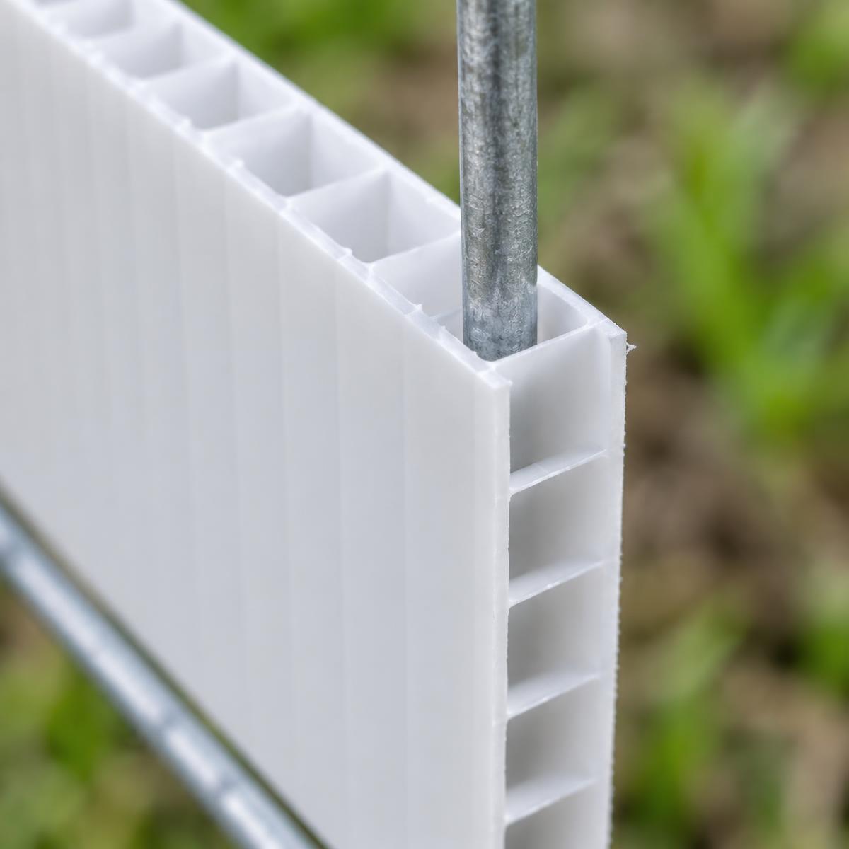 Close up of a coroplast sign corner showing the flutes with an H-stake wire entering one flute